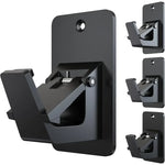 Supports adhésifs pour tringle à rideau sans perçage en couleur noir sur un mur blanc