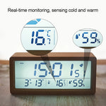 Horloge de table en bois noir affichant température et humidité
