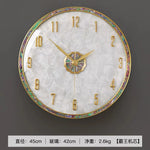 horloge murale moderne or blanc cadran marbré aiguille salon étude