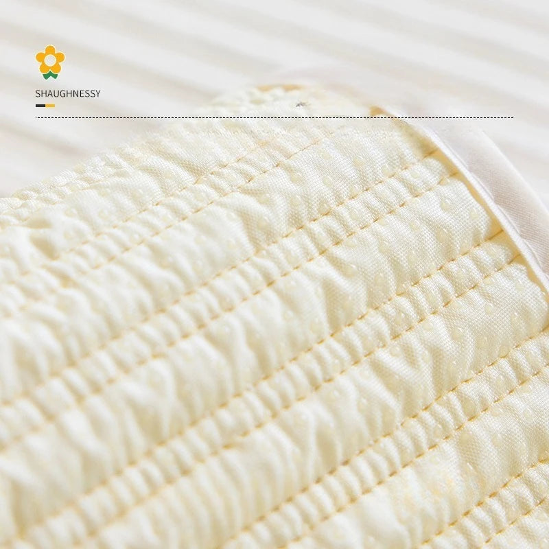 Gros plan sur le motif plissé d'un tissu doux et délicat de couleur crème.