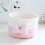 panier rangement rose blanc rayures horizontales noeud décoratif réutilisable polyestère enfantin cordelette organisation jouets