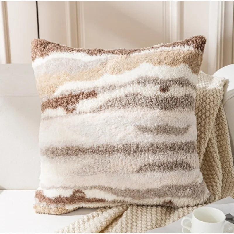 Coussin douillet aux rayures beiges et blanches, créant une ambiance confortable et cocooning dans le salon.