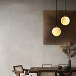 suspension lumineuse moderne marbre translucide câble noir socle doré élégante chambre salon étude