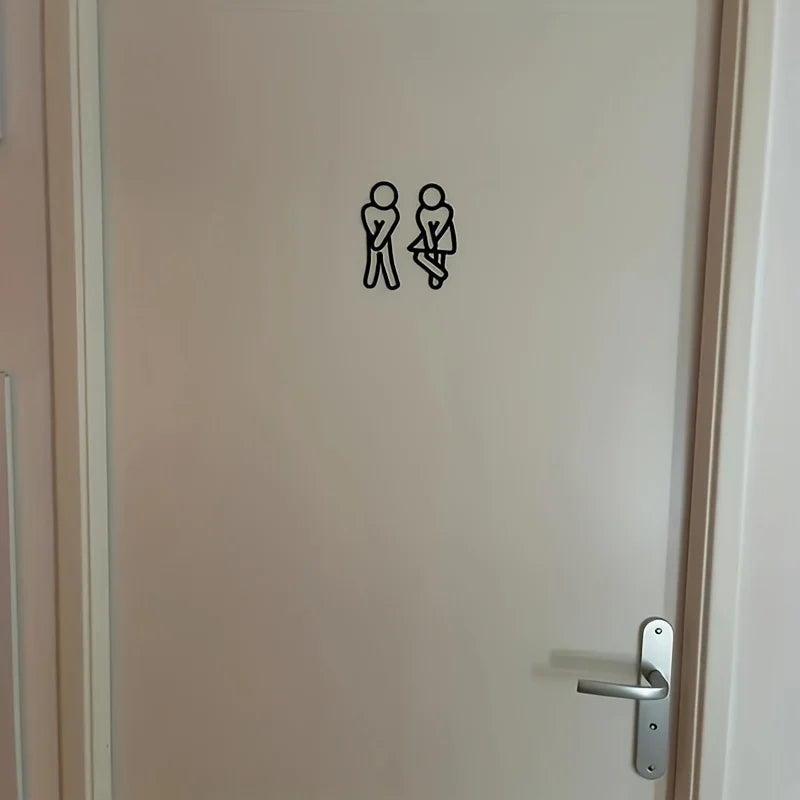 signalisation toilettes homme femme pictogrammes relief surface mate noir blanc minimaliste humoristique sans électricité