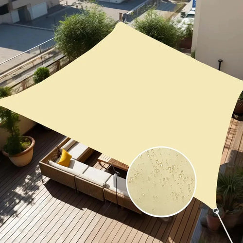 Voile d'ombrage rectangulaire beige installée dans un jardin