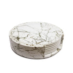 Un ensemble de sous-verres ronds en marbre blanc avec des motifs de fissures, créant un aspect élégant et raffiné.