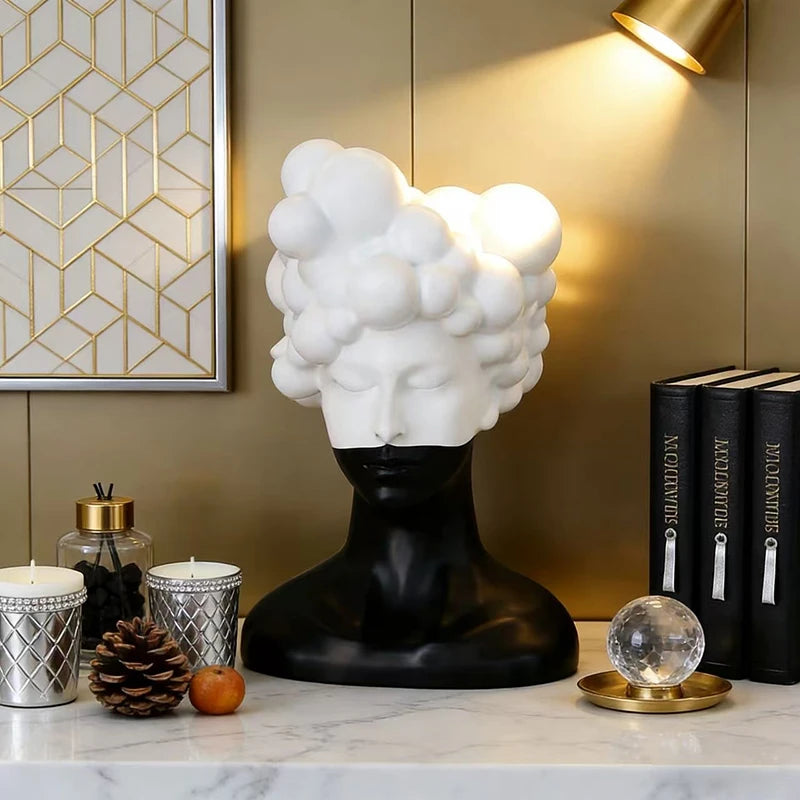 statue tête noire blanche texture mat moderne abstraite bougie concombre loupe livres lampe