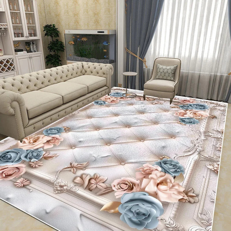 Un grand tapis à motifs floraux roses et bleus, avec un canapé beige capitonné et un fauteuil assorti, dans un salon élégant et lumineux.