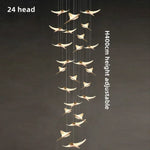 suspension lumineuse or oiseaux stylisés contemporaine minimaliste salon chaînes fixations métal lumière blanche chambre
