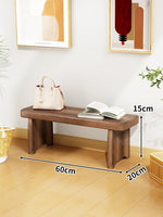 Banc bois marron clair texture naturelle moderne salon tabouret sac main livre ouvert decoration