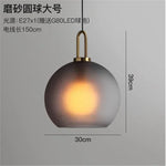 suspension lumineuse moderne gris fumé doré verre mat métal poli ampoule filament visible chambre
