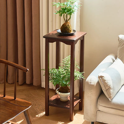 Porte-plante en bois massif à deux niveaux de couleur or dans un salon moderne