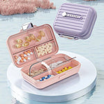 boîte pilules moderne rose clair violet blanc rayures verticales clics pilules différentes couleurs tailles