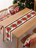 Élégante nappe de table de Noël rouge et verte ornée de fleurs de poinsettia et de motifs de sapins.