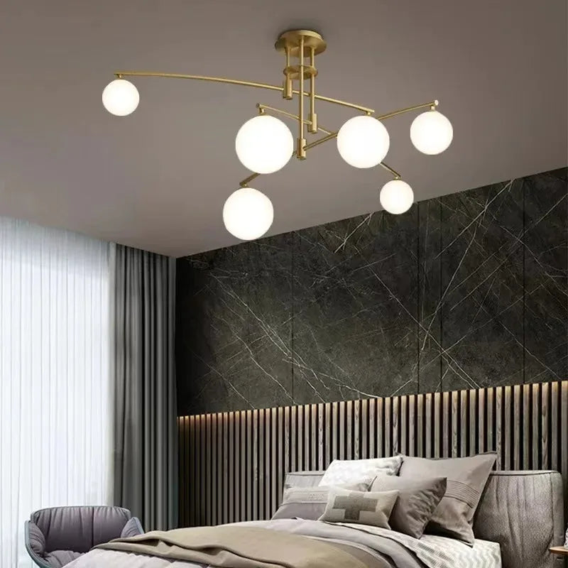 luminaire suspension moderne sphères translucides structure métallique dorée éclairage salon salle manger chambre