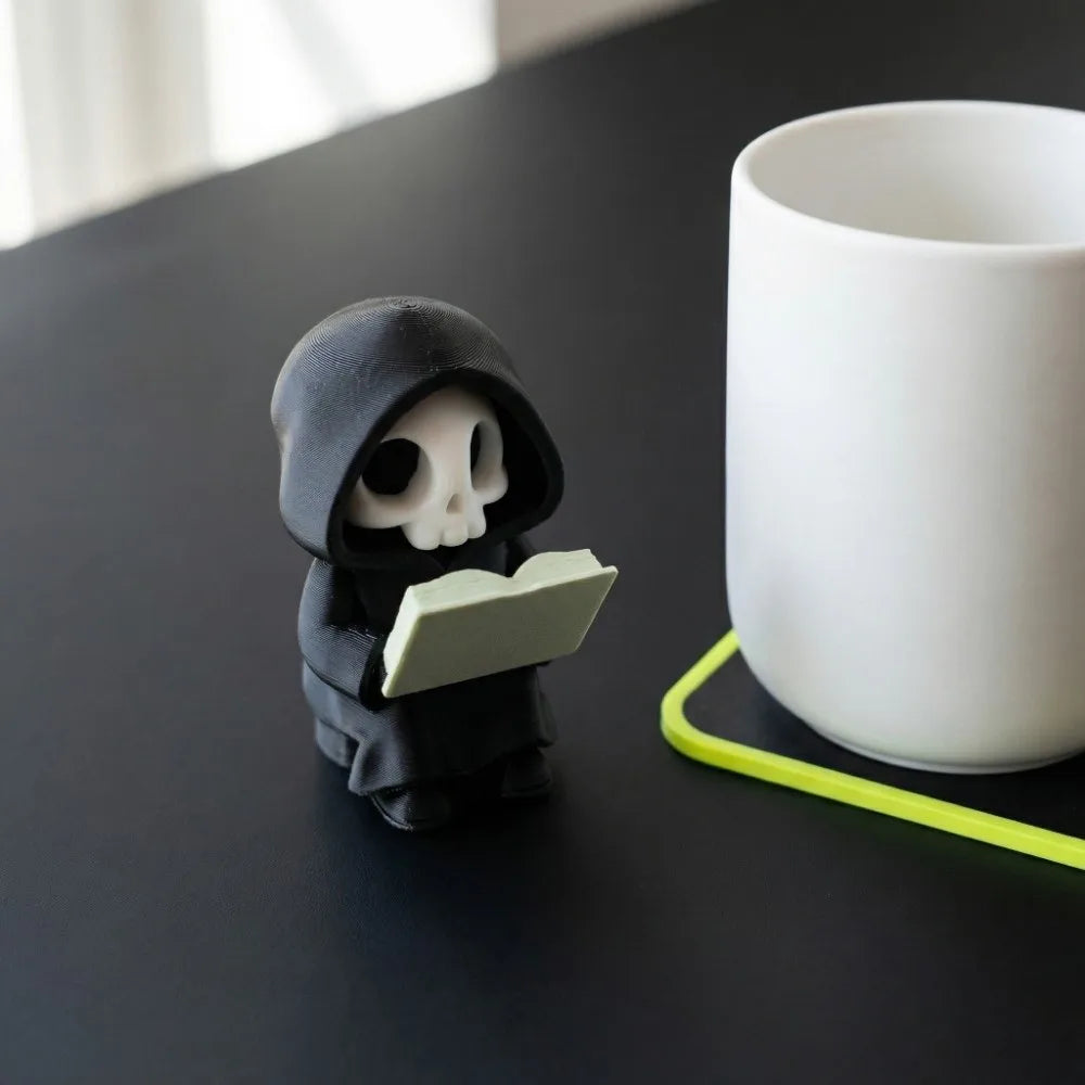 figurine gothique squelette lecture statuette fantôme noire minimaliste texture matestone livre blanc