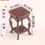 table basse bois rose classique gravures artisanal marron clair pot plante figurine cadre photo