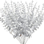 bouquet artificiel feuilles vertes naturel minimaliste ruban blanc vase blanc tapis beige ornement extérieur