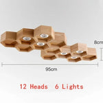 lumière suspendue bois clair nid d'abeille hexagonal modernes led câbles argentés structure géométrique