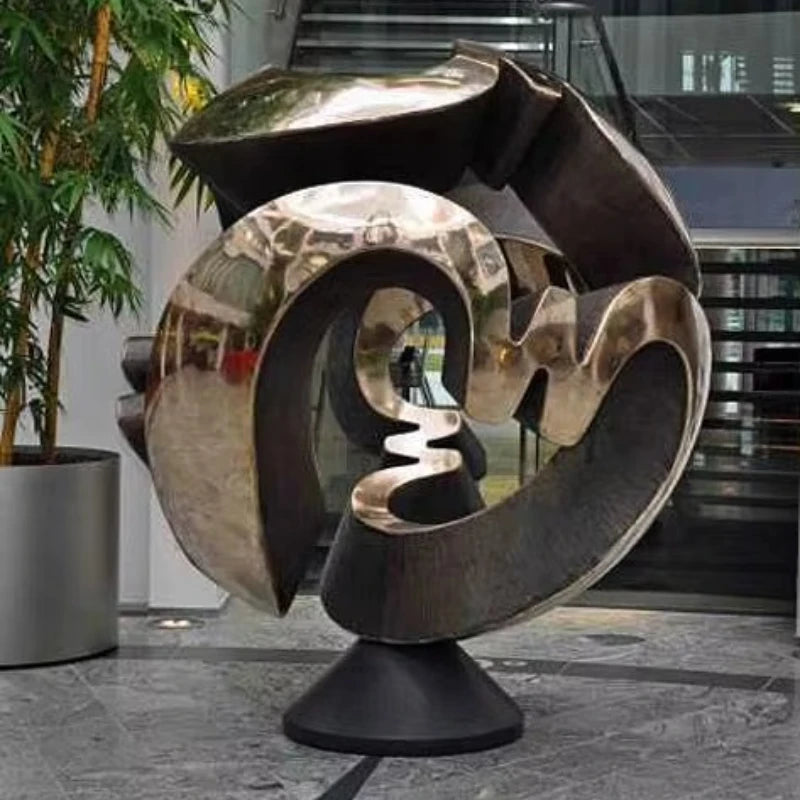 sculpture abstraite métal poli toroïdale forme circulaire décor jardin moderneextérieur