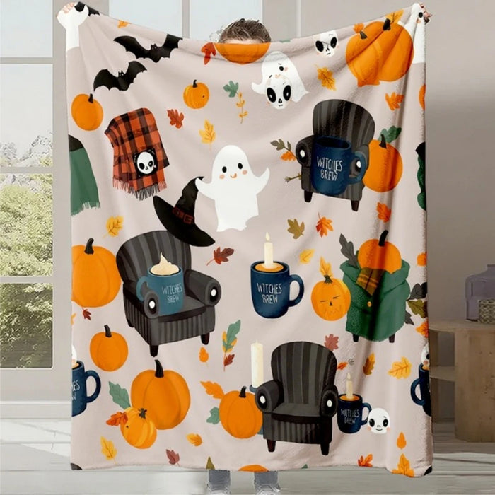 Une couverture douillette et festive avec des éléments d'Halloween tels que des citrouilles, des fantômes et des tasses "Sorcières en groupe", créant une ambiance automnale et conviviale.