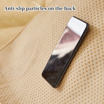 Le téléphone portable est posé sur un tissu perforé, indiquant la présence de particules antidérapantes sur le dos de l'appareil.