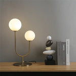 lampe table moderne or blanc sphères translucides câble noir base plate