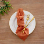 serviette table carrée orange franges moderne élégante fourchettes cuillères assiettesbranches séchées guirlande bougie parfumée