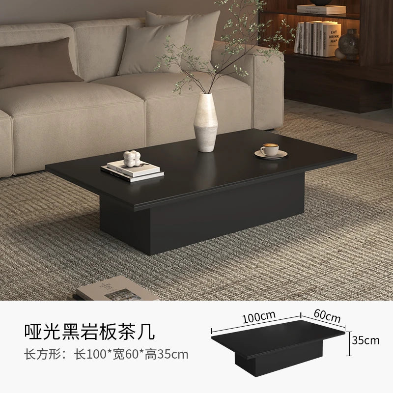 table basse moderne minimaliste noir blanche surface lisse tapis branches tasses livres coussins