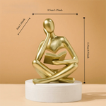 figurine deco moderne or noir blanc personne assise livre socle chambre abstraction minimalisme