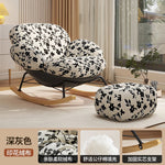 fauteuil bascule moderne beige noir orange roulettes coussin repos minimaliste salon