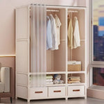 armoire vêtements moderne blanche rangées tiroirs compartiments rideau paires vêtements suspendus panier ours tasse