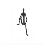 statues modernes minimalistes figures humaines assises noir texture brut forge lunettes livresintérieur