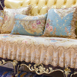 Élégant canapé capitonné avec des coussins de couleurs pastel ornés de riches motifs floraux et de bordures décoratives.