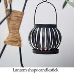 lanterne moderne minimaliste métal noir suspension bougie décoration intérieure contemporain porte chandelier abstrait