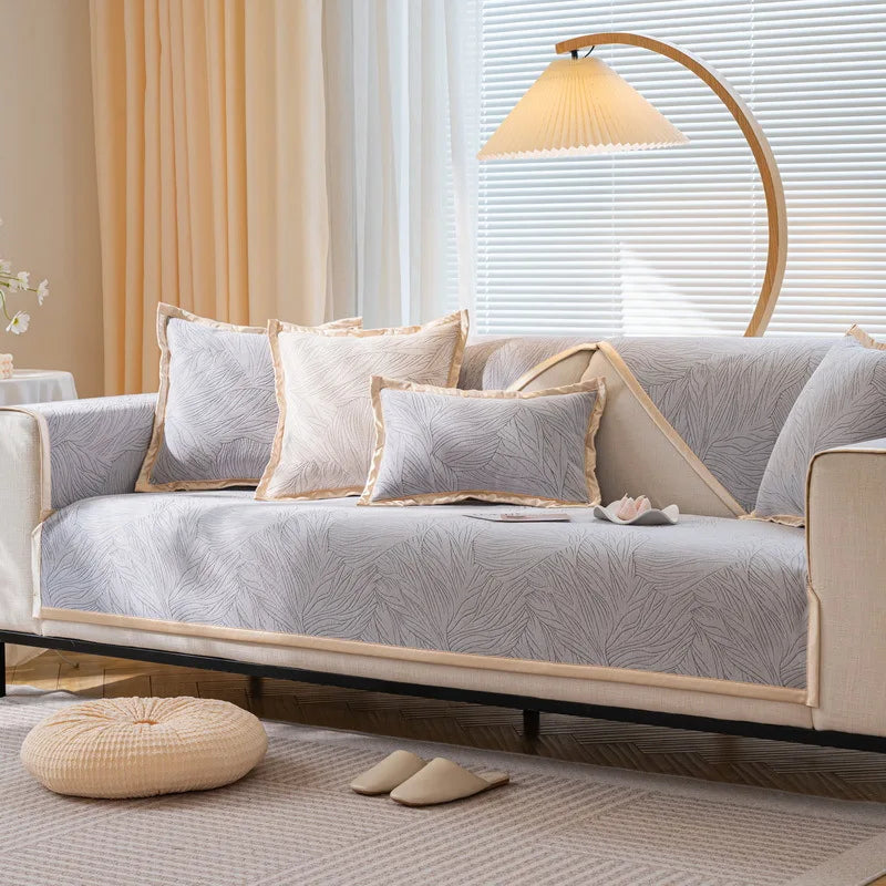 Un canapé confortable avec des oreillers décoratifs, éclairé par une lampe de sol, créant une atmosphère chaleureuse et accueillante dans cette pièce.