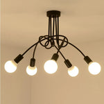 suspension lumineuse moderne noir doré ampoules blanches structure spirale fixation câbles métallique