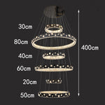 chandelier suspendu moderne plusieurs niveaux anneaux cristal transparents noir doré