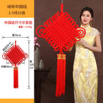 guirlande traditionnelle chinoise tissée artisanale rouge motifs géométriques pompon ruban doré festive printemps