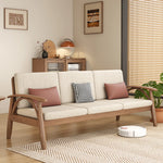 canapé places scandinave beige clair fauteuil pied poule moderne tapis géométrique terracotta blanc