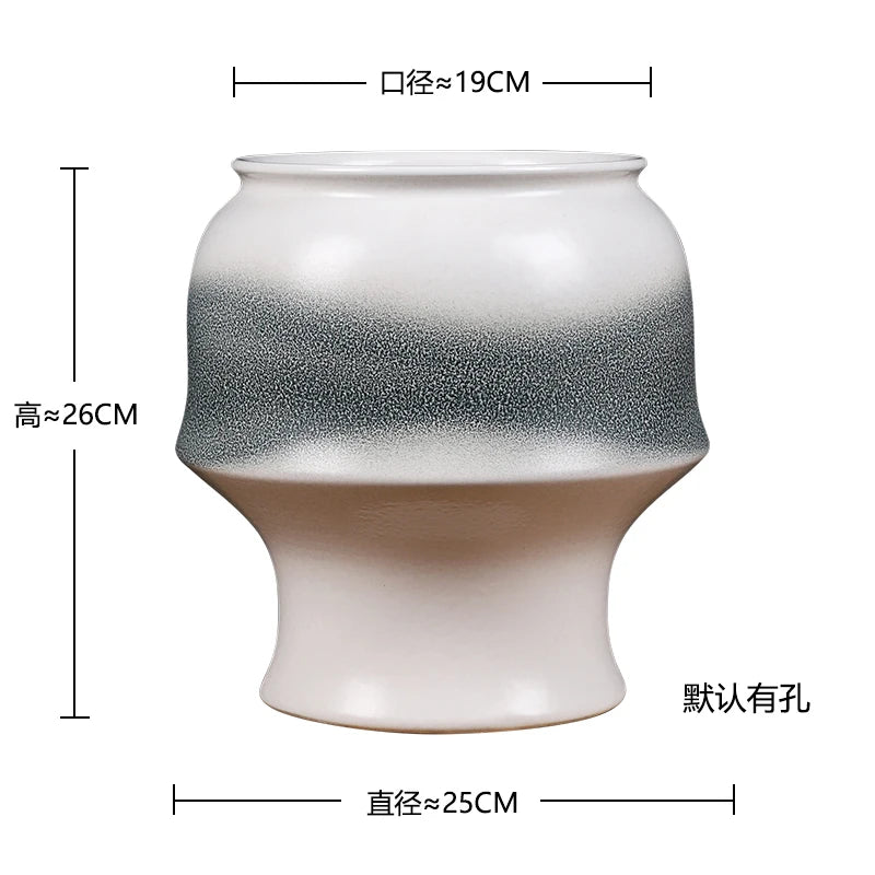 Vase en céramique blanc et noir avec un design marbré, d'une hauteur d'environ 26 cm et d'un diamètre d'environ 19 cm.