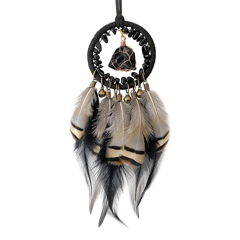 Capteur de rêves bohème décoratif en plumes marron et noir avec un cristal minéral au centre.