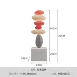 décoration intérieure sculpture pierre équilibrée socle marbre nuance beige contemporain minimaliste salon chambre