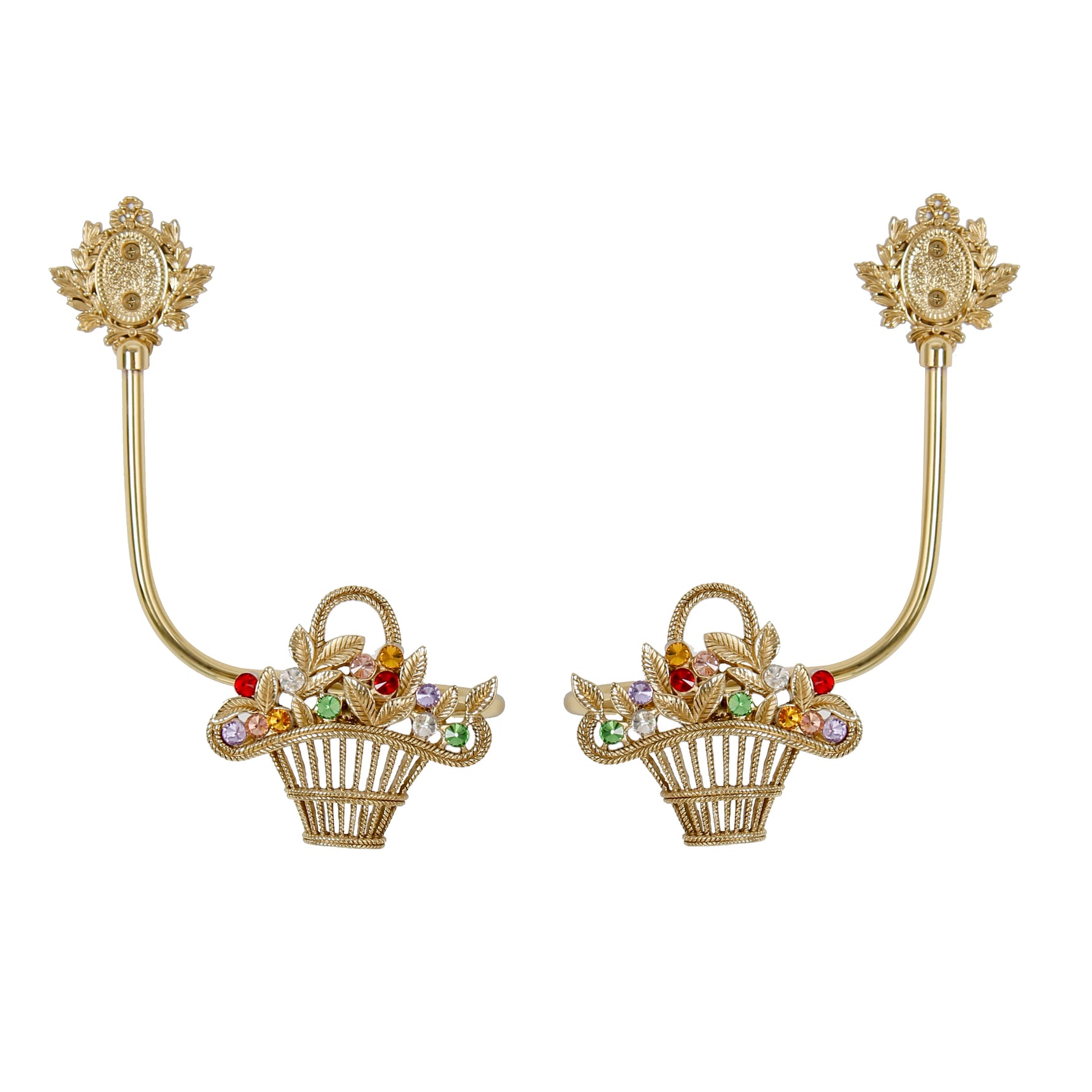 Deux élégantes barrettes à cheveux dorées ornées de corolle de fleurs multicolores et de feuilles dorées, disposées de part et d'autre d'un espace blanc.