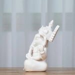 statue ganesha décorative asiatique résine sculptée beige clair blanc cassé fleurs roses plantes vertes