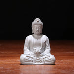 statue bouddha zen blanc gris bois décoratif assiette cigarettes tapis fibres naturellements éléments divers