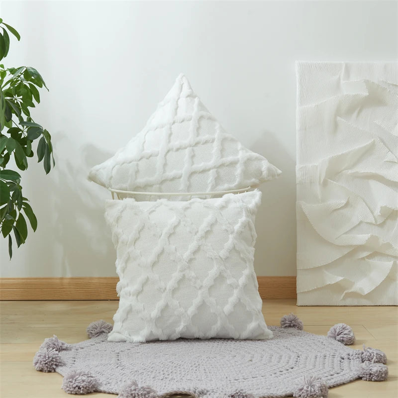 taies d'oreiller géométriques coussins blancs motifs pompons gris tapis doré salon decoration