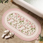tapis bain rose clair fleurs vertes bordure ornée résistant décoloration moderne classique ovale 40x60cm