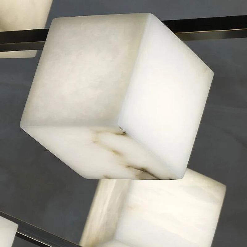 suspension lumineuse moderne marbre noir blanc or rose fixée câbles chambre salon