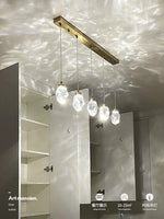 lampe suspendue or transparent cristal facettes géométriques moderne élégante tringles câbles